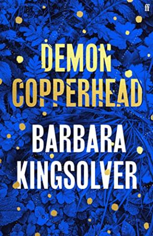 Cover of the book Demon Copperhead, featuring the title in gold letters set against a leaf-patterned blue backdrop.