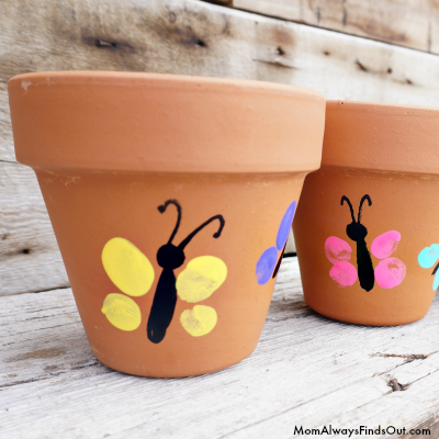 terra cotta brown planter with yellow and pink thumbprint painted butterflies