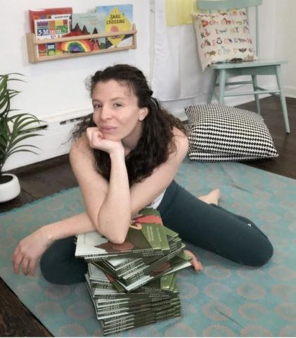 yoga instructor leaning on stack books