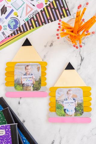 yellow, pink and gray popsicle sticks making a frame that looks like a pencil.