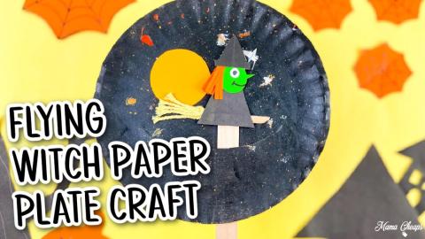 black paper plate with orange moon and green witch on a broom