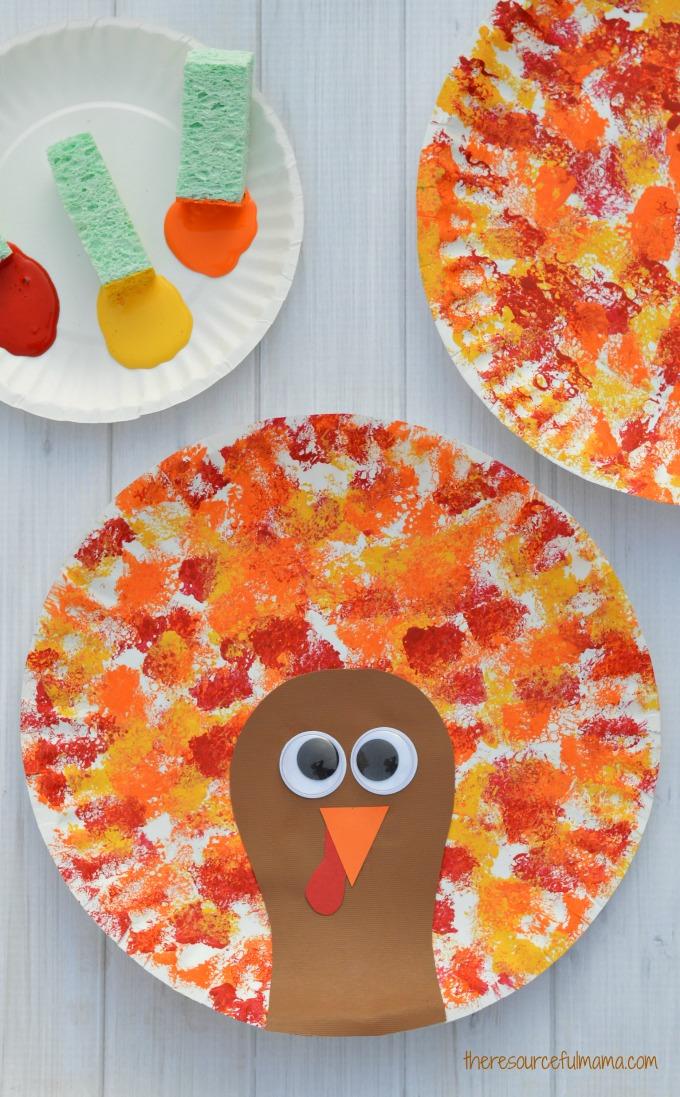 red, orange, yellow sponge paint with brown cardstock turkey and googly eyes on a paper plate